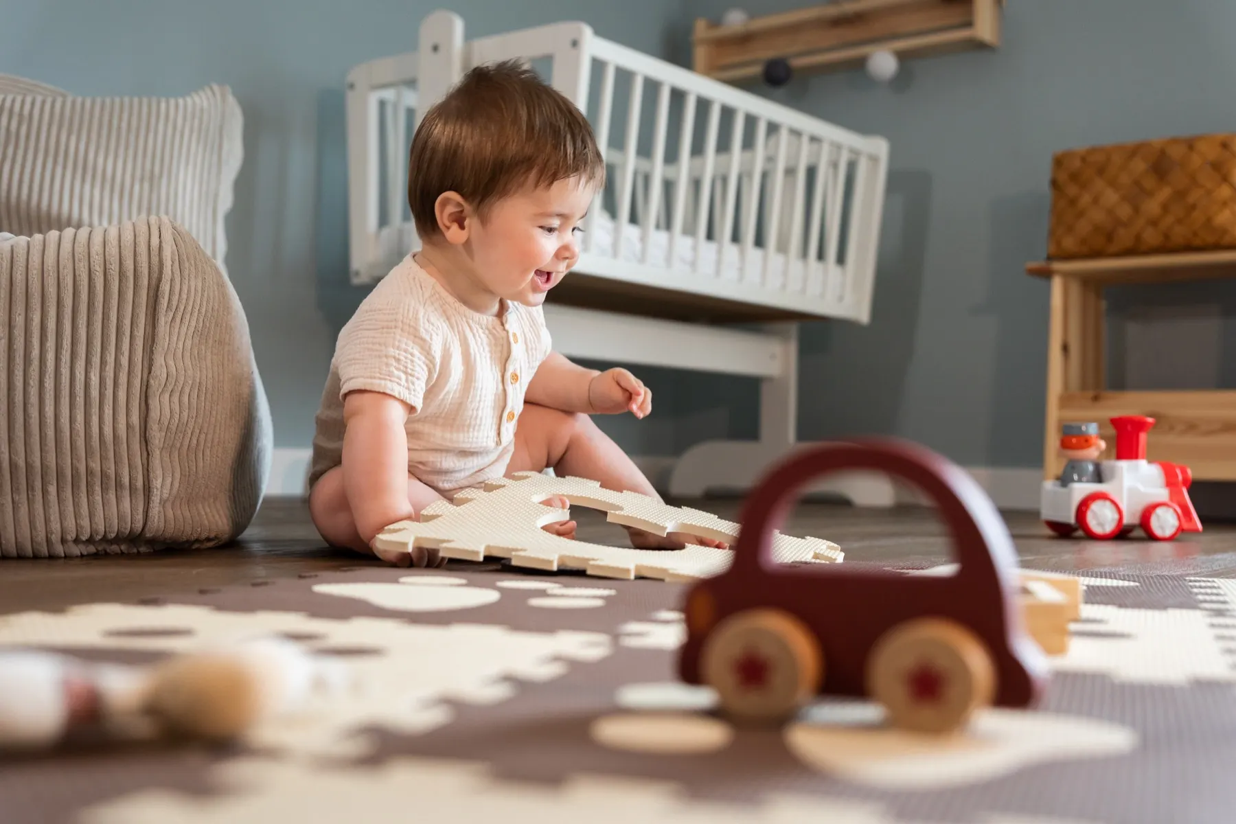 Un petit garçon joyeux joue avec des jouets en bois
